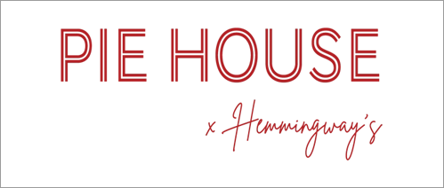 A green banner with red lettering that says " the house is coming up."